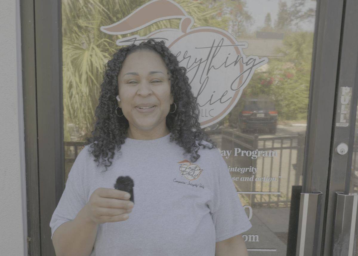 ADT Director Carolina Hunt at the front door of an Everything Peachie day program